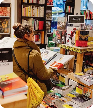 Readers browsing stacks of books in a shop
